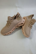 Pair of tan athletic shoes on a light gray background
